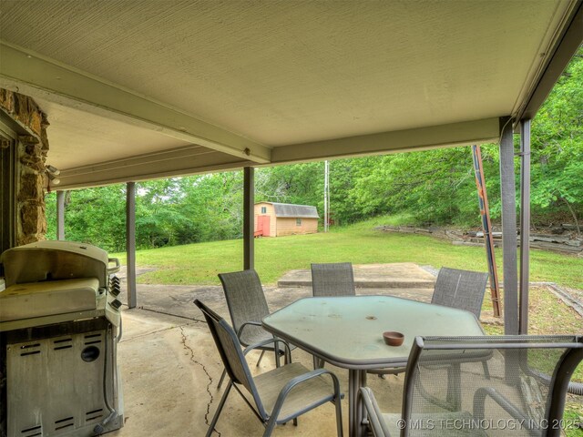 6551 S 41st St E, Muskogee, OK 74403 - view of patio / terrace with outdoor dining area and an outbuilding