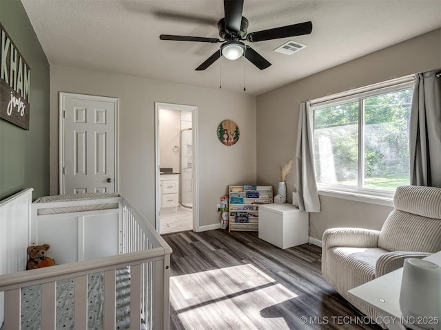 1149 N Hickory Pl, Broken Arrow, OK 74012 - bedroom featuring wood finished floors, baseboards, ensuite bathroom, and a ceiling fan
