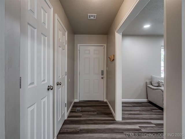 1149 N Hickory Pl, Broken Arrow, OK 74012 - doorway to outside featuring a textured ceiling, dark wood-style floors, and baseboards