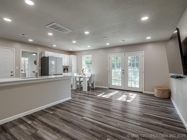 1149 N Hickory Pl, Broken Arrow, OK 74012 - living area with french doors, dark wood finished floors, recessed lighting, baseboards, and a textured ceiling