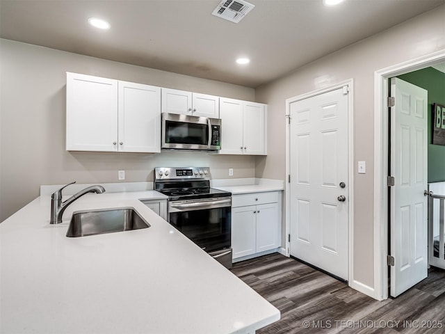 1149 N Hickory Pl, Broken Arrow, OK 74012 - kitchen featuring appliances with stainless steel finishes, a sink, dark wood-style floors, white cabinets, and recessed lighting