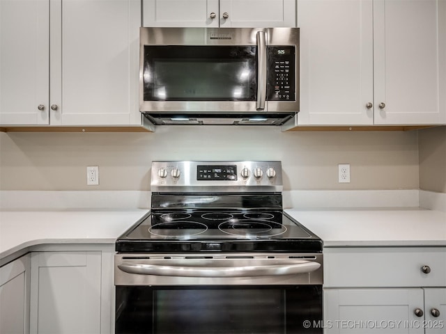 1149 N Hickory Pl, Broken Arrow, OK 74012 - kitchen featuring appliances with stainless steel finishes, light countertops, and white cabinetry