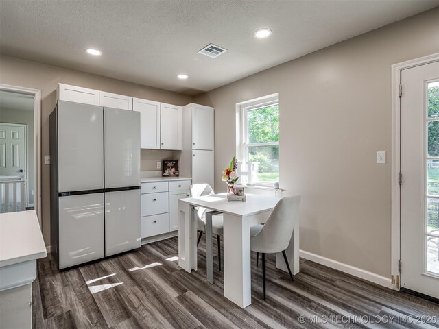 1149 N Hickory Pl, Broken Arrow, OK 74012 - kitchen with freestanding refrigerator, dark wood-style flooring, white cabinets, light countertops, and recessed lighting