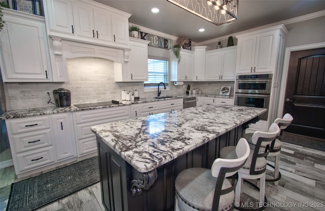 110 W Zachry Ln, Stigler, OK 74462 - kitchen featuring stainless steel appliances, ornamental molding, white cabinets, light wood-type flooring, and recessed lighting