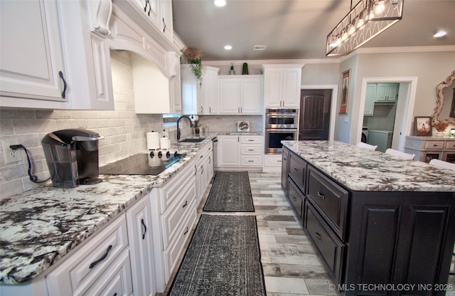 110 W Zachry Ln, Stigler, OK 74462 - kitchen with double oven, white cabinetry, crown molding, black electric cooktop, and a sink