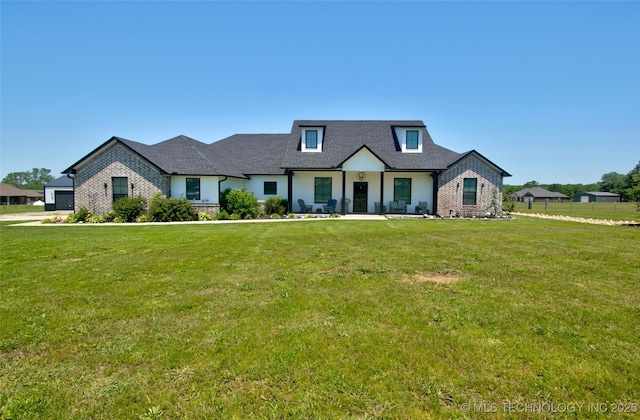 110 W Zachry Ln, Stigler, OK 74462 - view of front of property featuring a front yard, roof with shingles, and brick siding