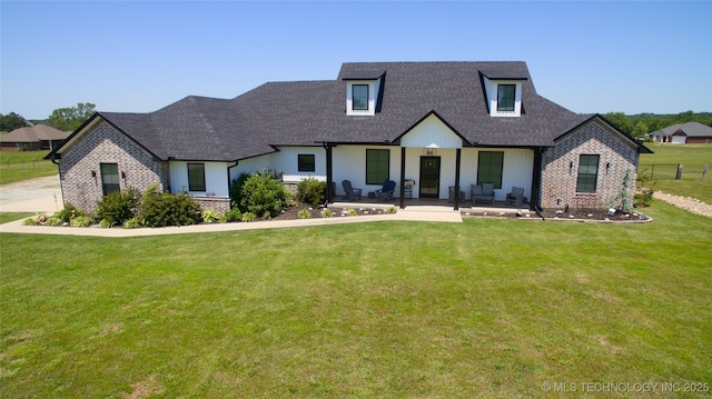 110 W Zachry Ln, Stigler, OK 74462 - view of front of home with a shingled roof, brick siding, and covered porch