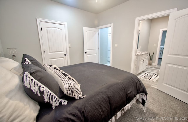 110 W Zachry Ln, Stigler, OK 74462 - bedroom featuring connected bathroom and light carpet