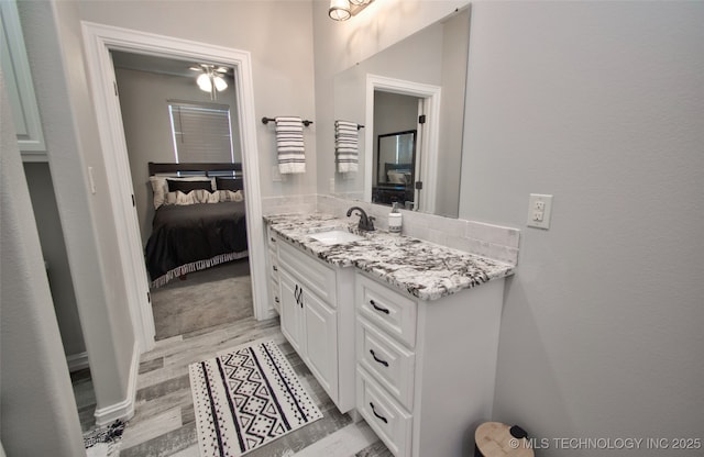 110 W Zachry Ln, Stigler, OK 74462 - bathroom featuring vanity, wood finished floors, and ensuite bath