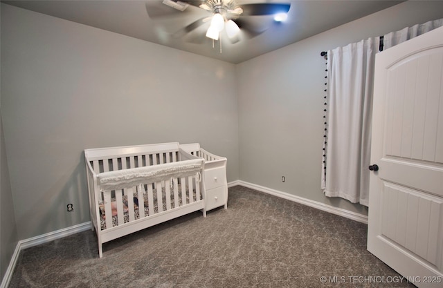 110 W Zachry Ln, Stigler, OK 74462 - bedroom featuring carpet floors, baseboards, a nursery area, and a ceiling fan