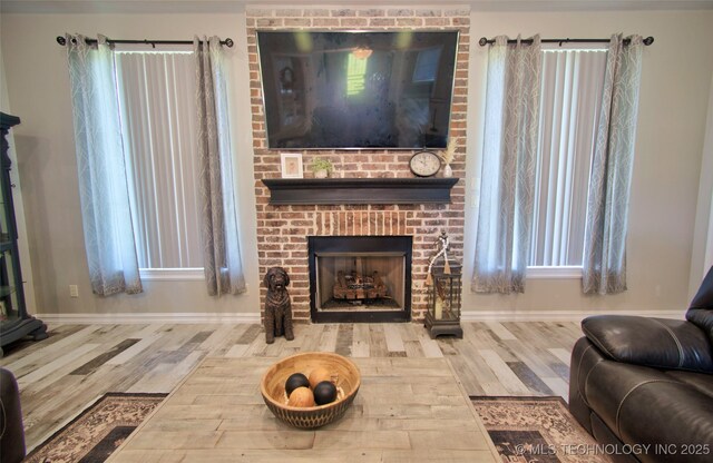 110 W Zachry Ln, Stigler, OK 74462 - living room with wood finished floors, a brick fireplace, and baseboards