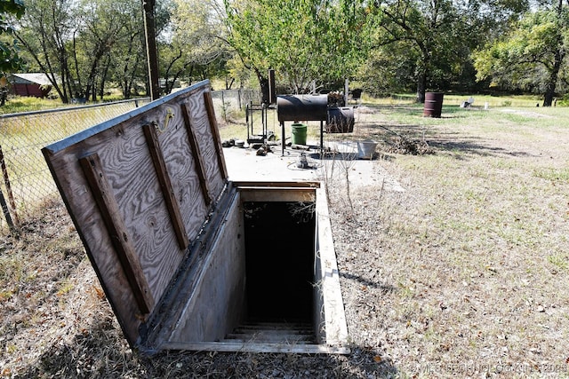 7457 S 105th St E, Braggs, OK 74423 - entry to storm shelter with fence and view of wooded area