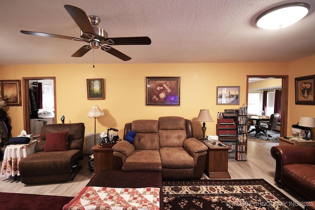 7457 S 105th St E, Braggs, OK 74423 - living area with light wood-type flooring, a ceiling fan, and a textured ceiling