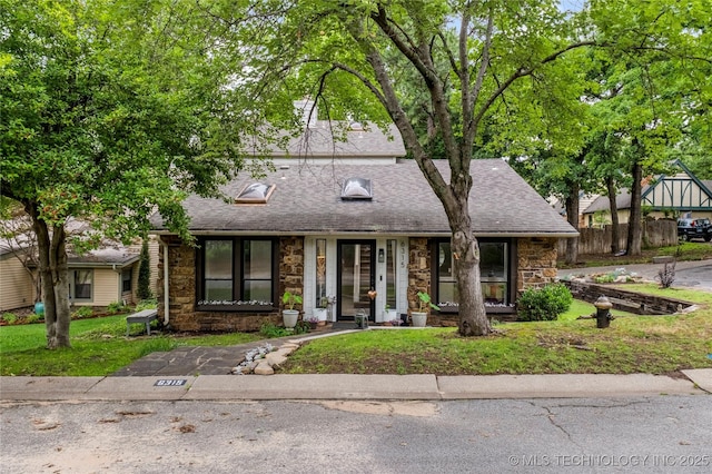6315 E 98th Pl, Tulsa, OK 74137 - view of front facade featuring stone siding, roof with shingles, and fence