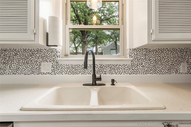 6315 E 98th Pl, Tulsa, OK 74137 - kitchen view of a sink, light countertops, white cabinets, and tasteful backsplash