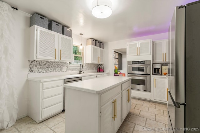 6315 E 98th Pl, Tulsa, OK 74137 - kitchen with appliances with stainless steel finishes, a sink, light countertops, and white cabinetry