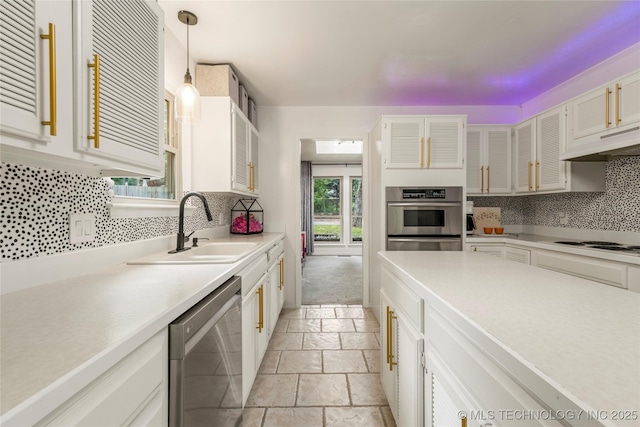 6315 E 98th Pl, Tulsa, OK 74137 - kitchen featuring stainless steel appliances, a sink, decorative backsplash, light countertops, and stone tile flooring