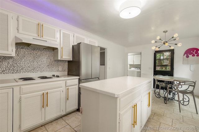 6315 E 98th Pl, Tulsa, OK 74137 - kitchen featuring white electric cooktop, under cabinet range hood, a chandelier, light countertops, and a center island