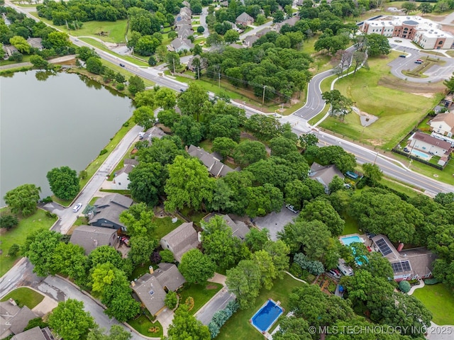 6315 E 98th Pl, Tulsa, OK 74137 - aerial perspective of suburban area with a large body of water and a tree filled landscape