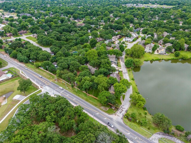 6315 E 98th Pl, Tulsa, OK 74137 - drone / aerial view of a nearby body of water, a tree filled landscape, and a major roadway