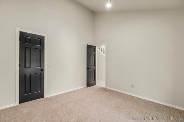 6315 E 98th Pl, Tulsa, OK 74137 - unfurnished room featuring carpet, high vaulted ceiling, and baseboards