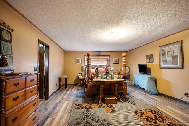 17711 E Archer St, Catoosa, OK 74015 - dining room with light wood finished floors, a textured ceiling, crown molding, and baseboards
