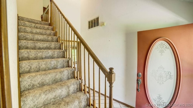 staircase with a high ceiling