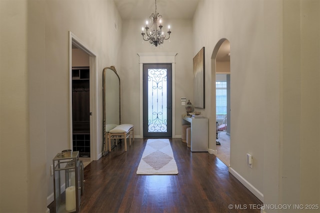 4314 S 132nd E Ave, Tulsa, OK 74134 - entryway with arched walkways, dark wood finished floors, a chandelier, a towering ceiling, and baseboards
