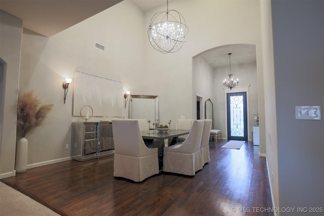 4314 S 132nd E Ave, Tulsa, OK 74134 - dining area featuring a chandelier, a high ceiling, dark wood-style flooring, arched walkways, and baseboards