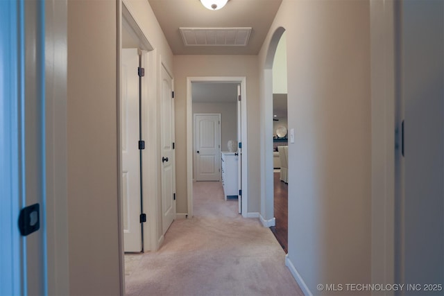 4314 S 132nd E Ave, Tulsa, OK 74134 - hallway featuring arched walkways, light colored carpet, and baseboards