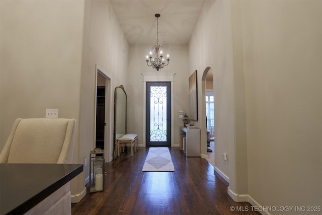 4314 S 132nd E Ave, Tulsa, OK 74134 - entryway with dark wood-type flooring, a chandelier, arched walkways, a towering ceiling, and baseboards