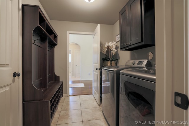 4314 S 132nd E Ave, Tulsa, OK 74134 - laundry area featuring cabinet space, washer and dryer, arched walkways, light tile patterned floors, and baseboards