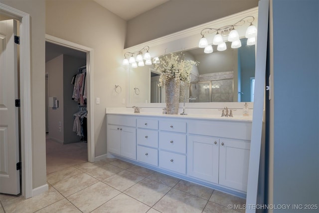 4314 S 132nd E Ave, Tulsa, OK 74134 - full bath featuring a stall shower, a spacious closet, tile patterned floors, double vanity, and baseboards