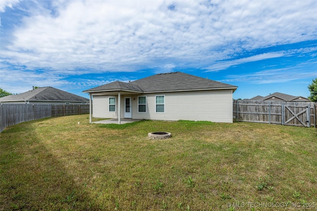back of property featuring a patio area and a fire pit