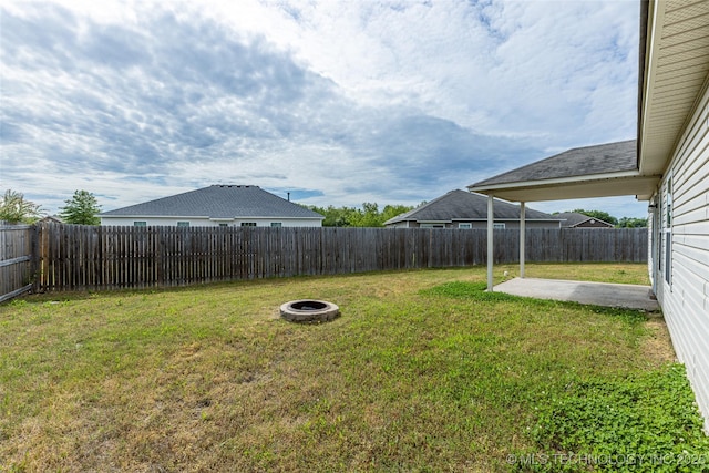 view of yard featuring a patio and a fire pit