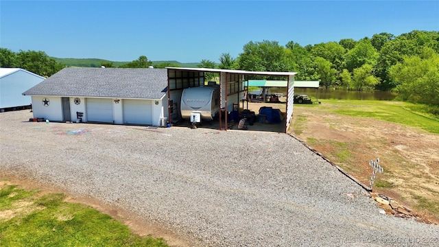 30190 W County Road 1240, Stigler, OK 74462 - garage with a water view and gravel driveway