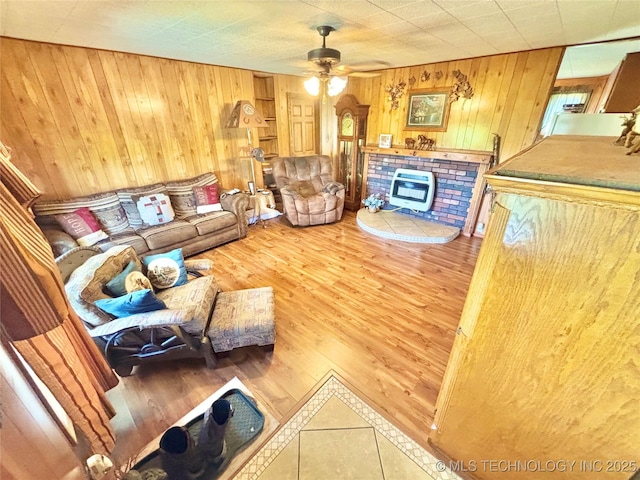 30190 W County Road 1240, Stigler, OK 74462 - living room with wooden walls, ceiling fan, wood finished floors, and heating unit