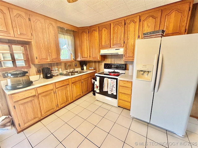 30190 W County Road 1240, Stigler, OK 74462 - kitchen with white appliances, under cabinet range hood, light countertops, and brown cabinetry
