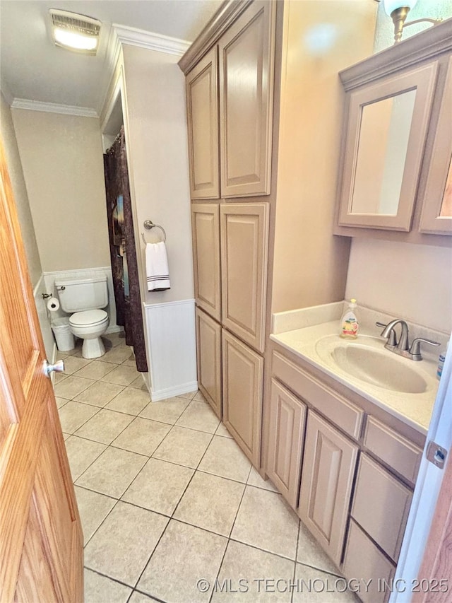 30190 W County Road 1240, Stigler, OK 74462 - full bathroom with tile patterned flooring, ornamental molding, toilet, vanity, and a wainscoted wall
