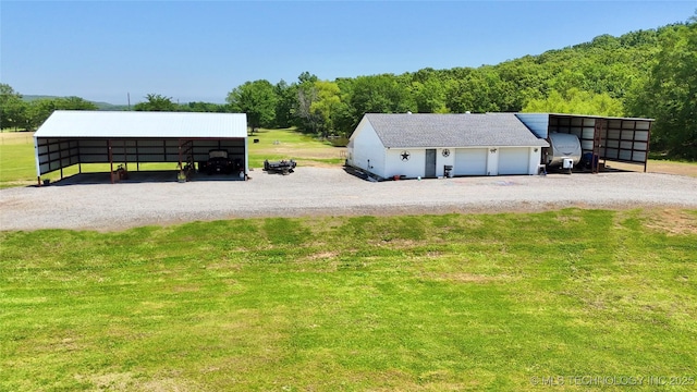 30190 W County Road 1240, Stigler, OK 74462 - view of side of home featuring driveway, a detached carport, a yard, and an outdoor structure