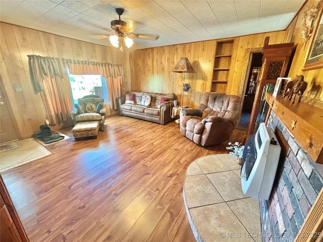 30190 W County Road 1240, Stigler, OK 74462 - living area with wooden walls, wood finished floors, a ceiling fan, and built in shelves