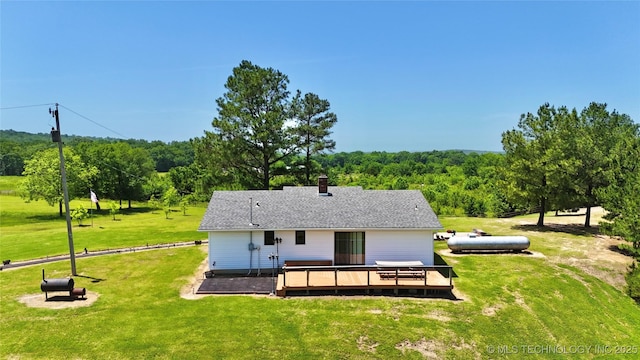 30190 W County Road 1240, Stigler, OK 74462 - back of property with a wooden deck, a view of trees, a yard, and a chimney