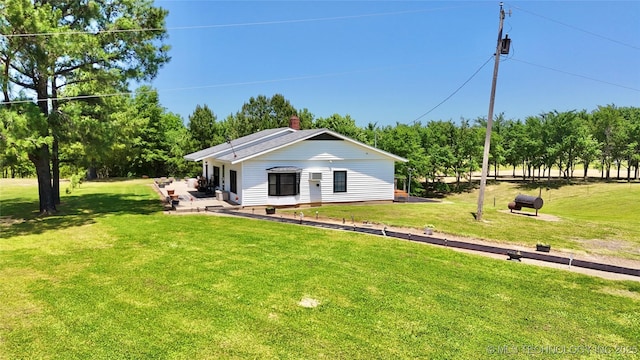 30190 W County Road 1240, Stigler, OK 74462 - rear view of house featuring a lawn and a patio