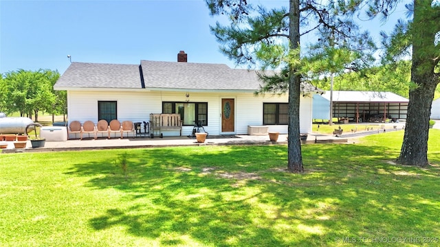 30190 W County Road 1240, Stigler, OK 74462 - back of property featuring a lawn, a chimney, and roof with shingles