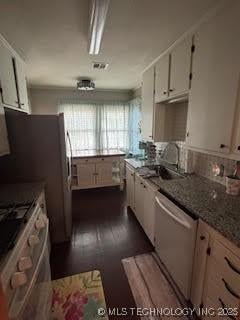 3527 S Knoxville Ave, Tulsa, OK 74135 - kitchen with dishwasher, range, white cabinets, dark wood-style floors, and a sink