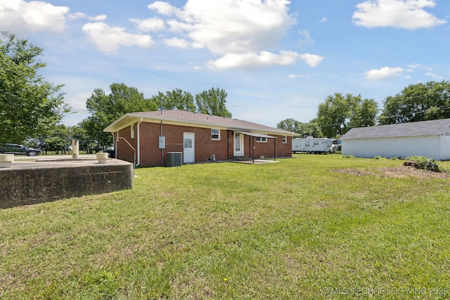 425 Mulberry Ave, Afton, OK 74331 - back of property with brick siding, a yard, and central air condition unit