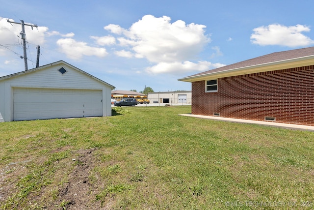425 Mulberry Ave, Afton, OK 74331 - view of grassy yard featuring a detached garage and an outbuilding
