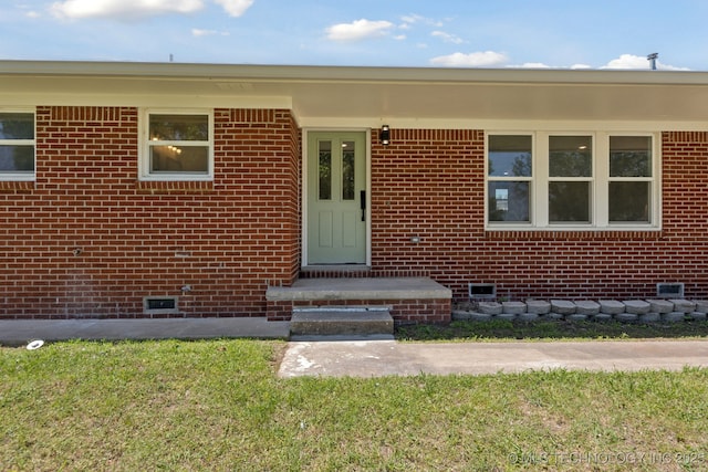 425 Mulberry Ave, Afton, OK 74331 - view of exterior entry with crawl space and brick siding