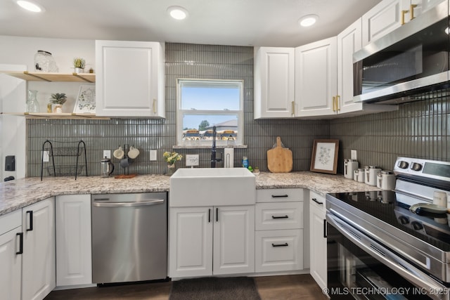 425 Mulberry Ave, Afton, OK 74331 - kitchen featuring appliances with stainless steel finishes, white cabinetry, decorative backsplash, a sink, and light stone countertops