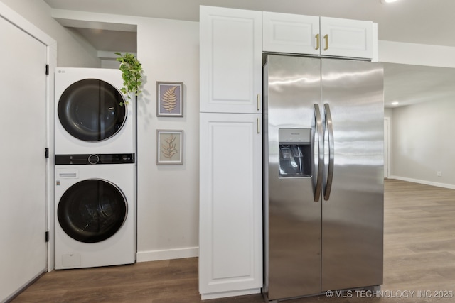 425 Mulberry Ave, Afton, OK 74331 - laundry room featuring stacked washer / dryer, baseboards, and wood finished floors